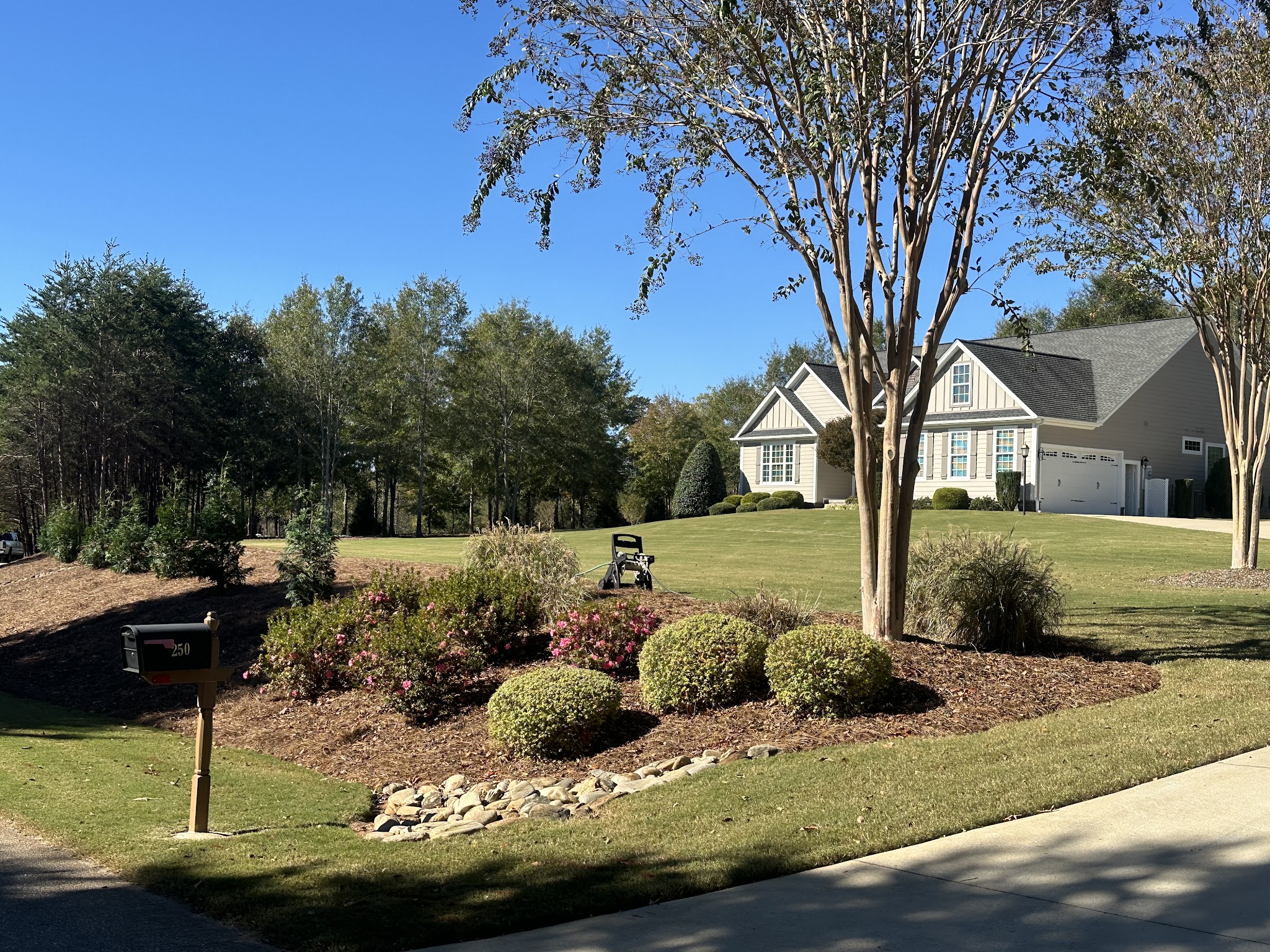 Landscaped front yard with mulch beds and a rock bed