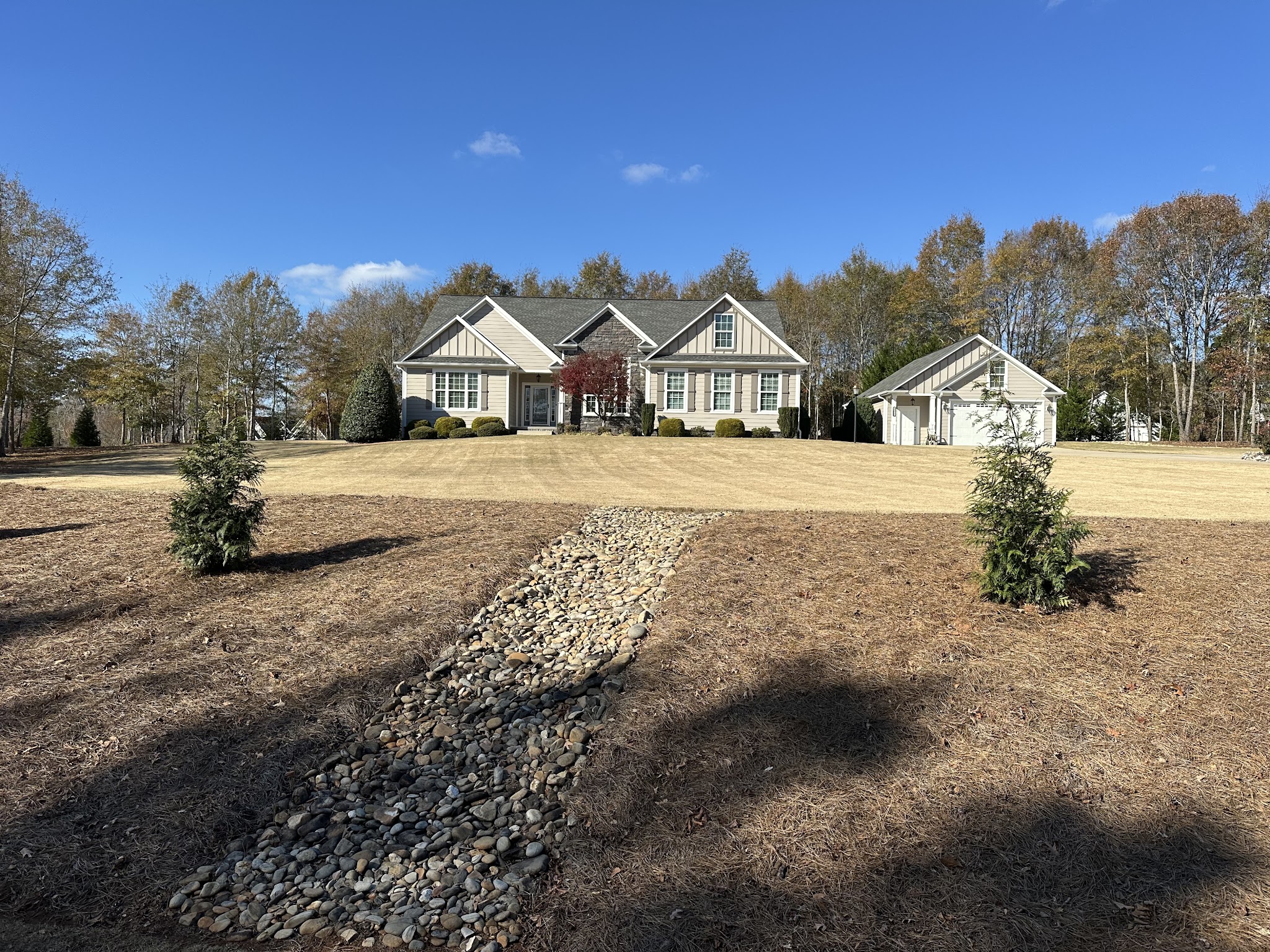 New plantings with a rock drainage bed